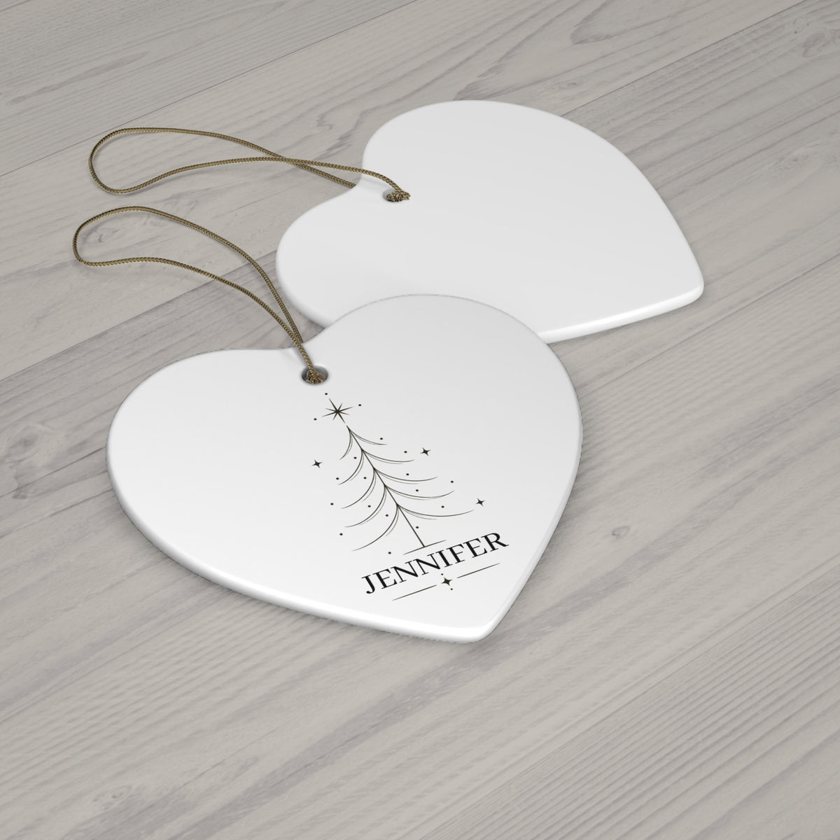 Heart Christmas tree name ornament with its blank back side on a wooden table