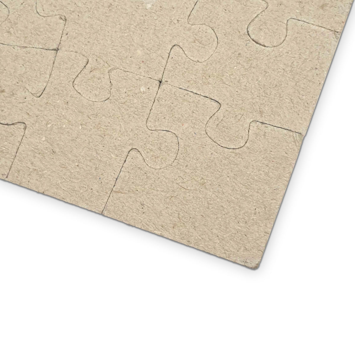 Back of the photo puzzle showing the plain chipboard pieces