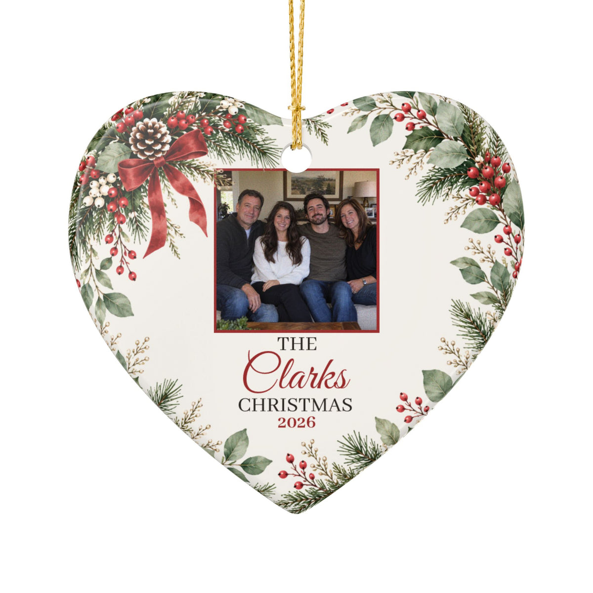 Heart-shaped personalized family photo ornament with gold string, close-up on white
