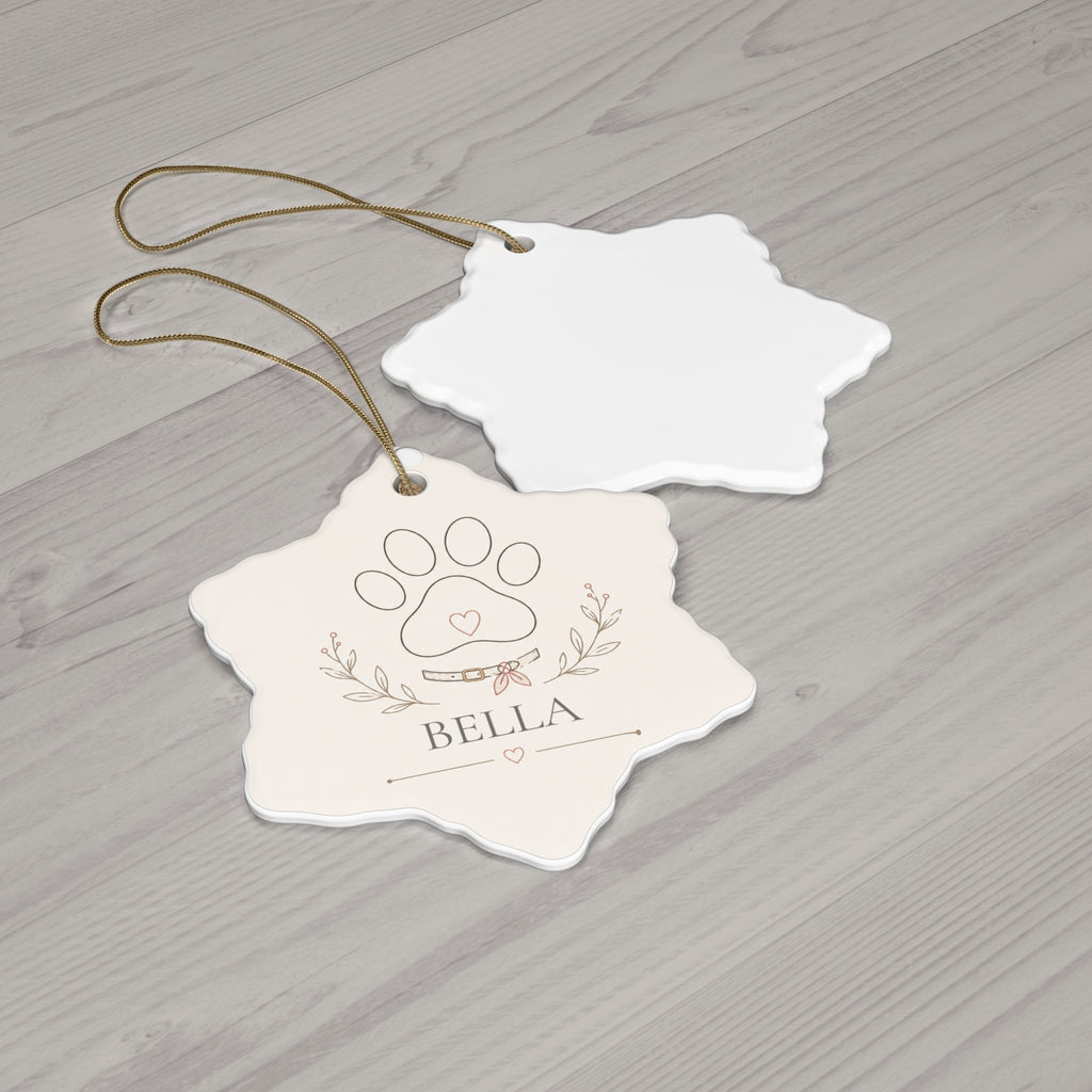 Snowflake paw print pet ornament with its blank back side on a wooden table