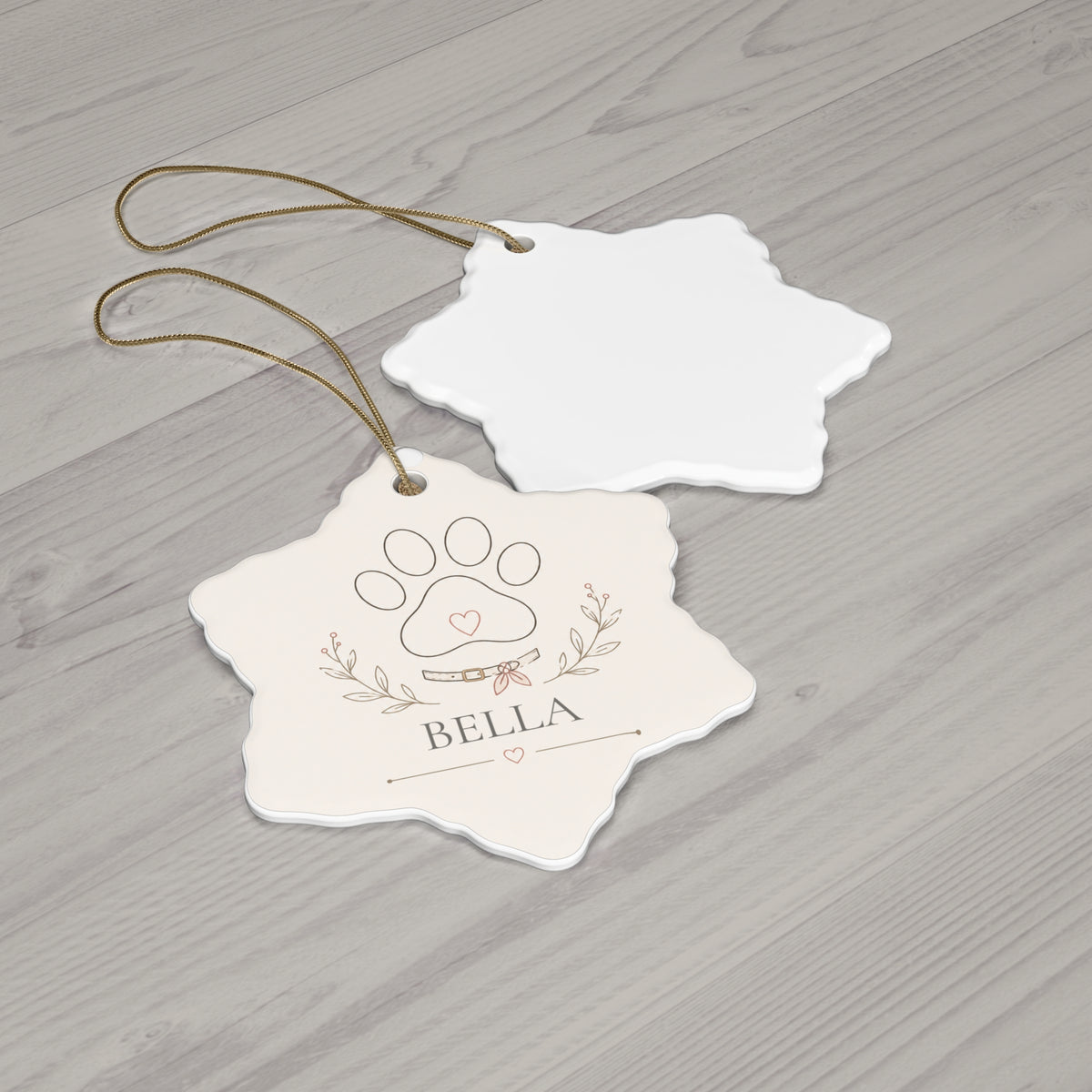 Snowflake paw print pet ornament with its blank back side on a wooden table