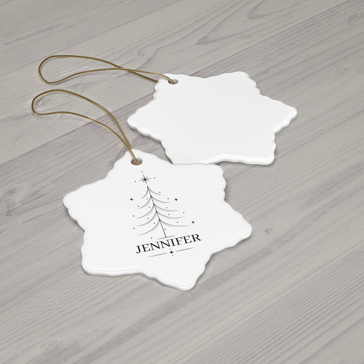 Snowflake Christmas tree name ornament with its blank back side on a wooden table