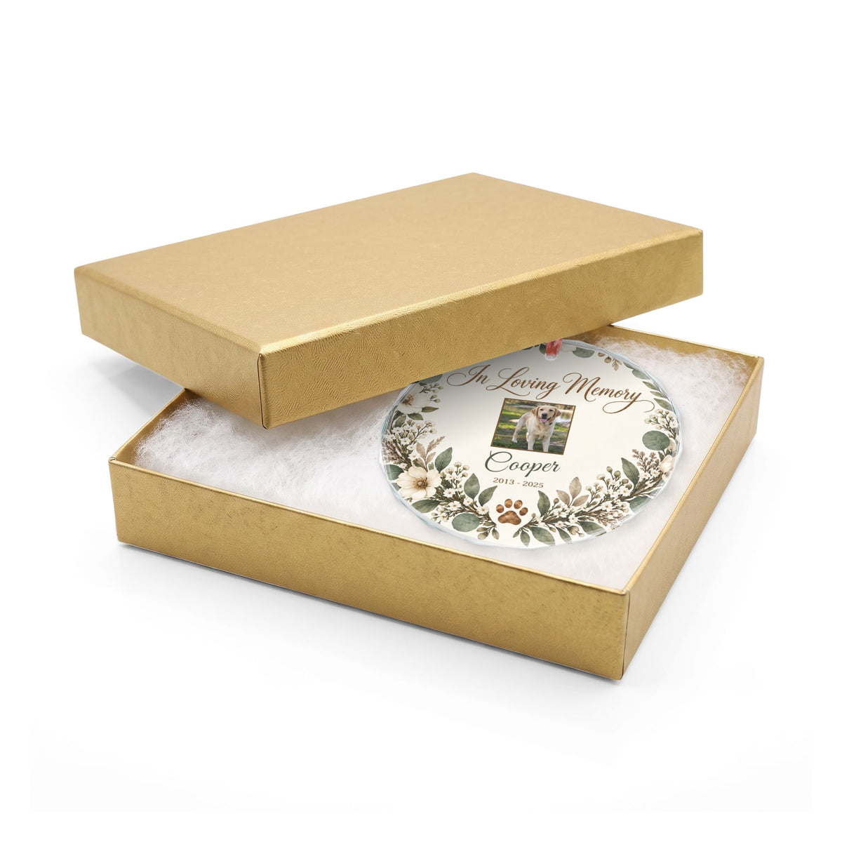Round pet memorial glass ornament in an open gold gift box