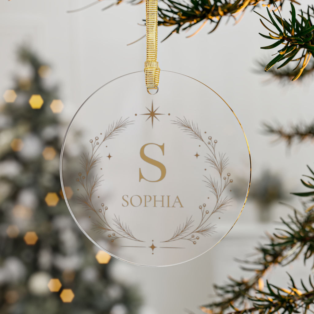 Clear acrylic monogram name ornament hanging on a Christmas tree