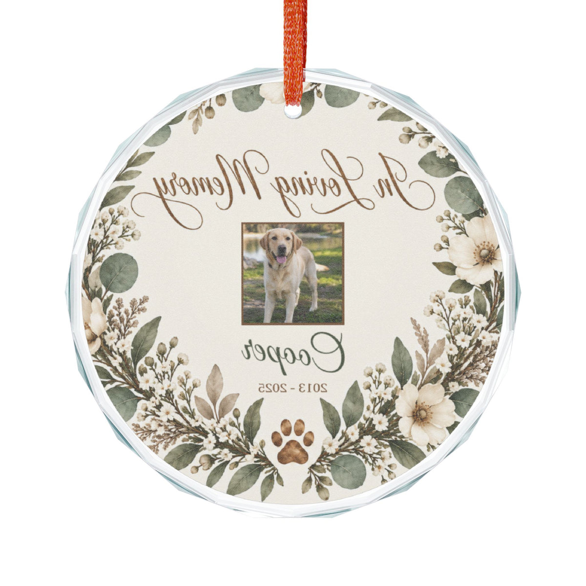 Round pet memorial glass ornament seen from the back with red ribbon