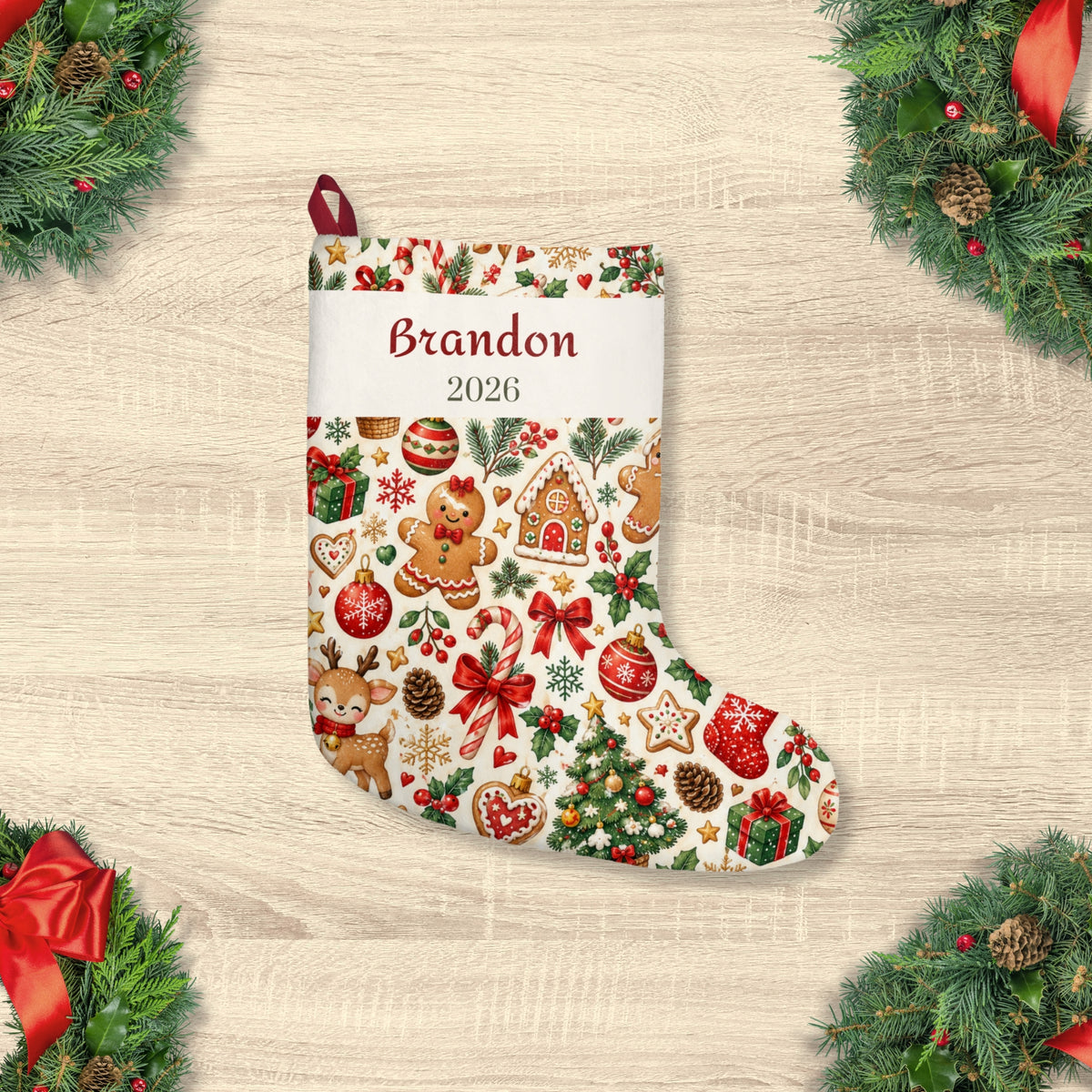 Personalized baby Christmas stocking with name and year, flat lay with pine and ornaments