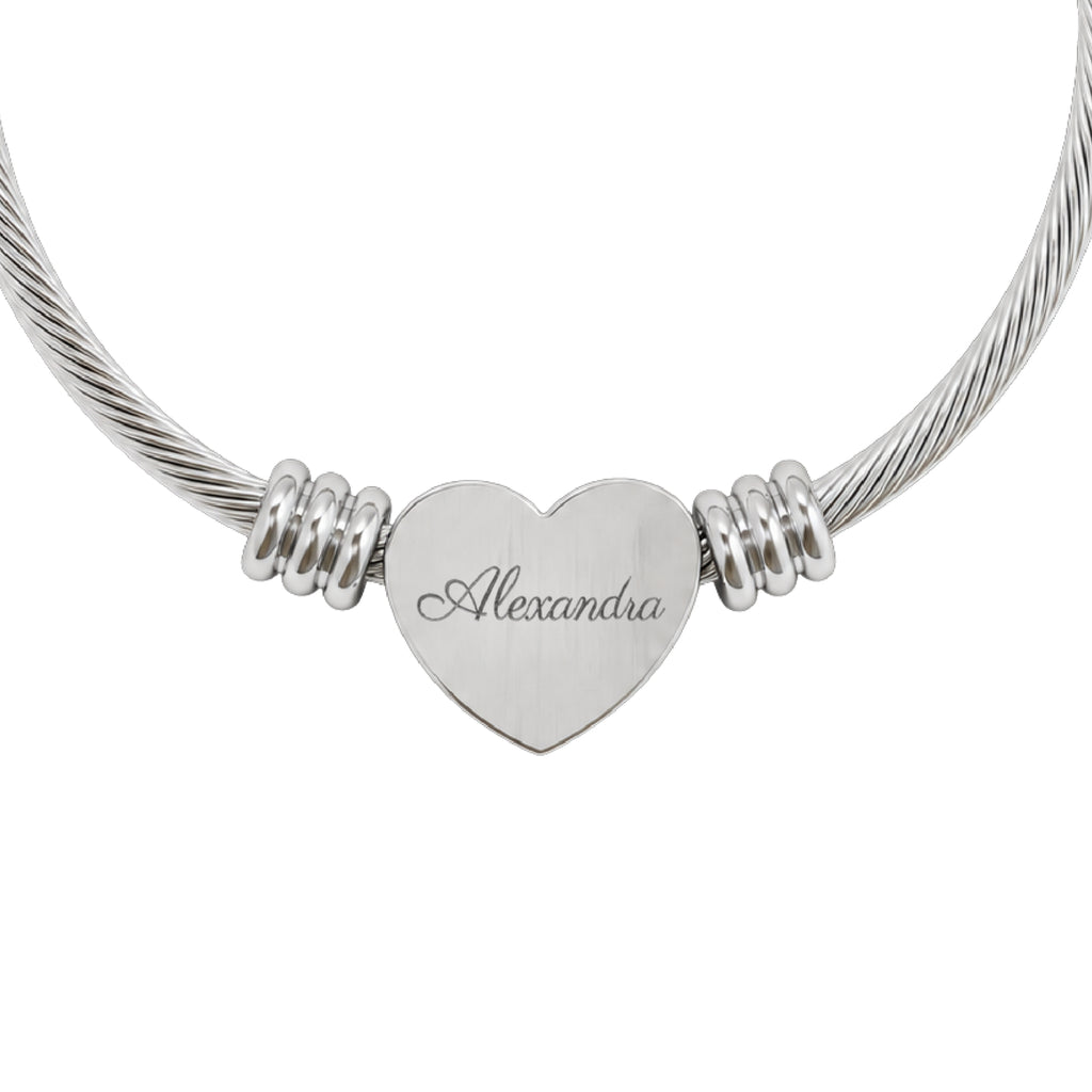 Personalized name heart cuff bracelet in silver stainless steel, heart charm engraved with a name in script, close-up
