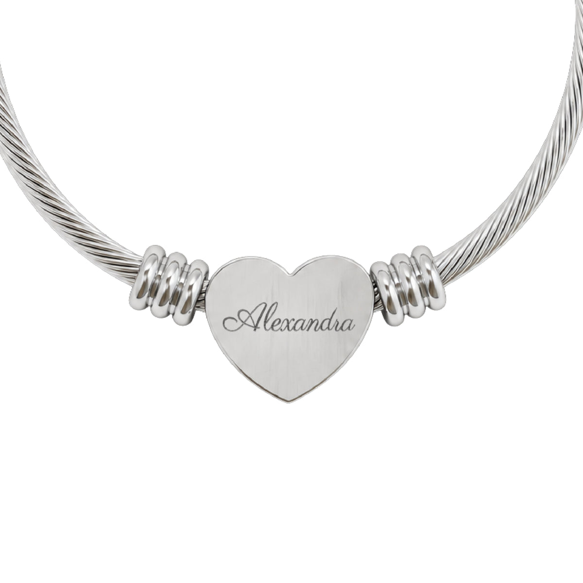 Personalized name heart cuff bracelet in silver stainless steel, heart charm engraved with a name in script, close-up