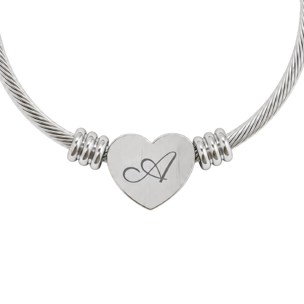 Personalized initial heart cuff bracelet in silver stainless steel, heart charm engraved with a script initial A, close-up