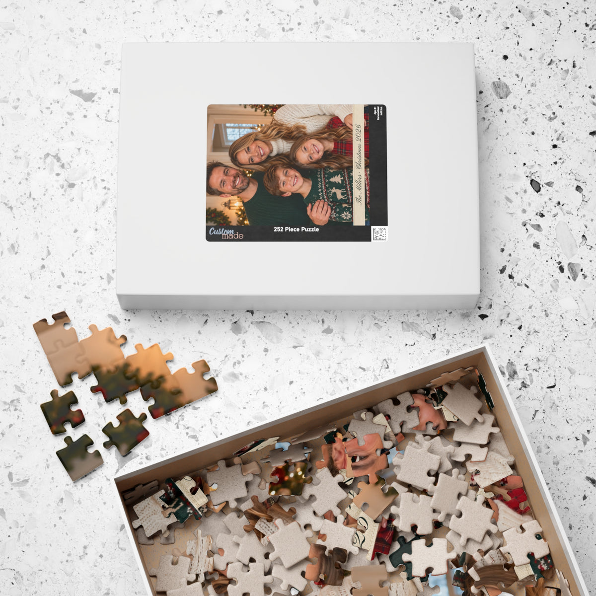 Personalized puzzle box with the family photo on the lid and pieces in a tray