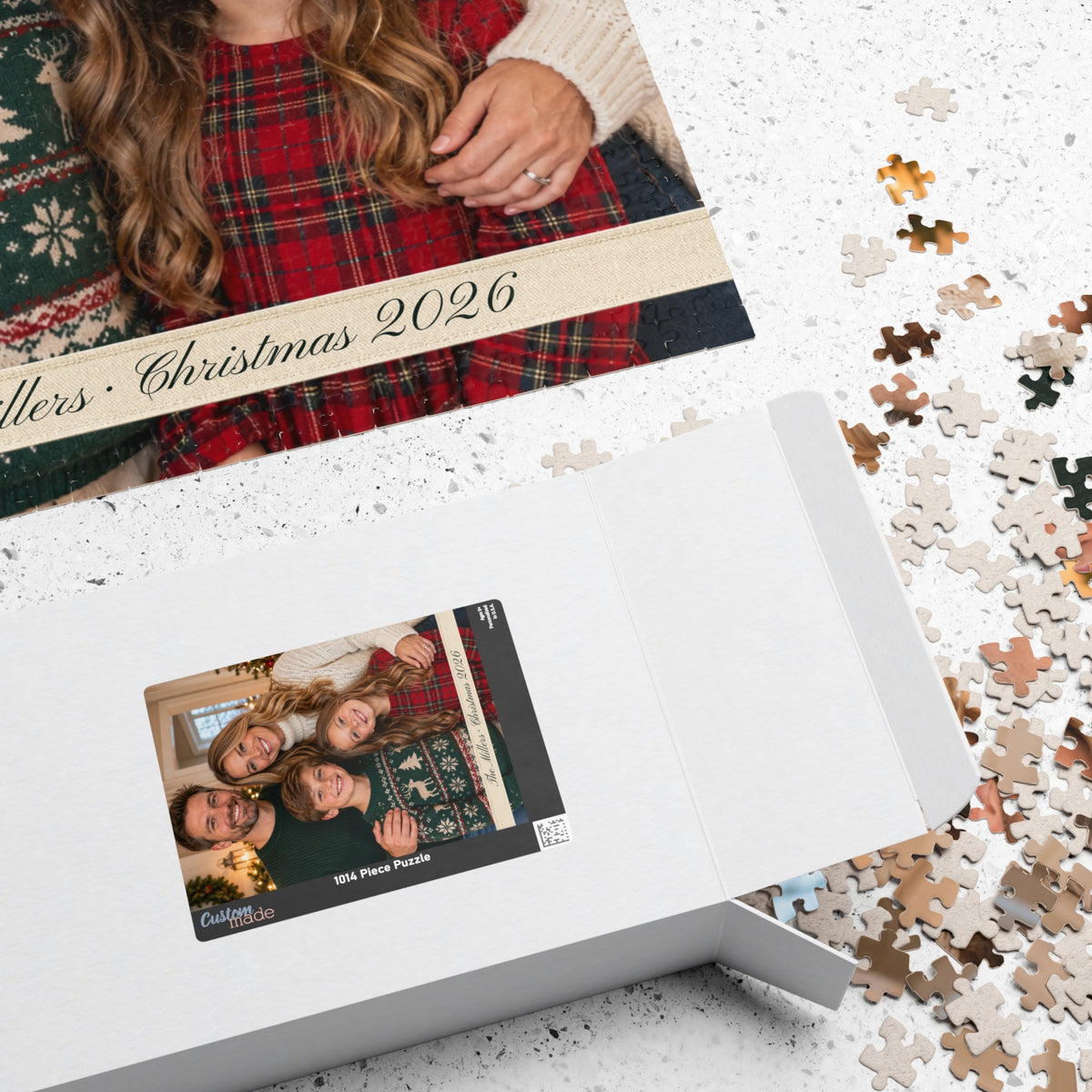 Photo puzzle box with the family photo on the lid next to loose pieces