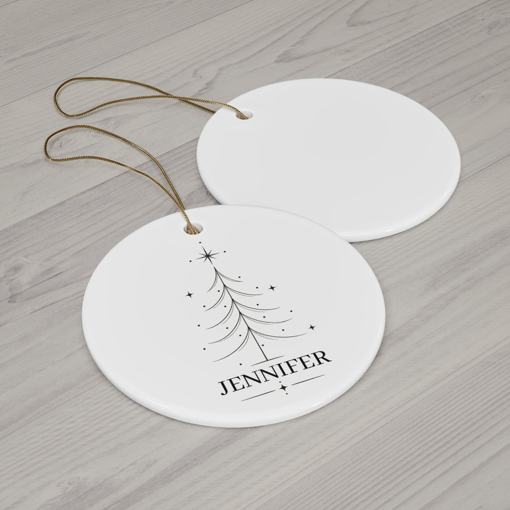 Round Christmas tree name ornament with its blank back side on a wooden table