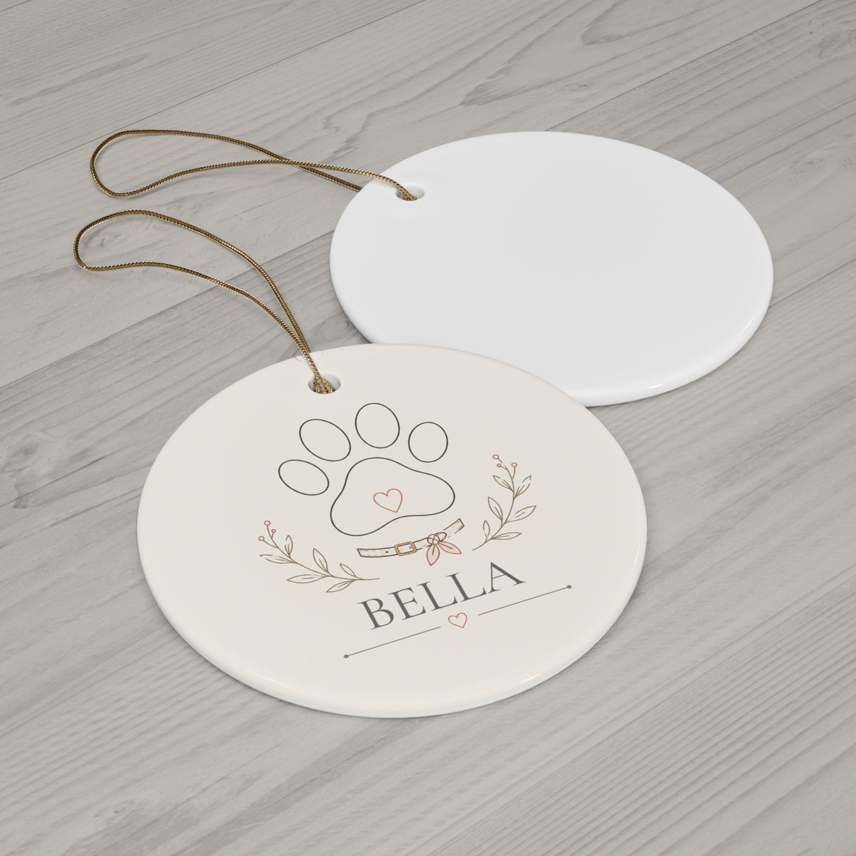 Round paw print pet ornament with its blank back side on a wooden table