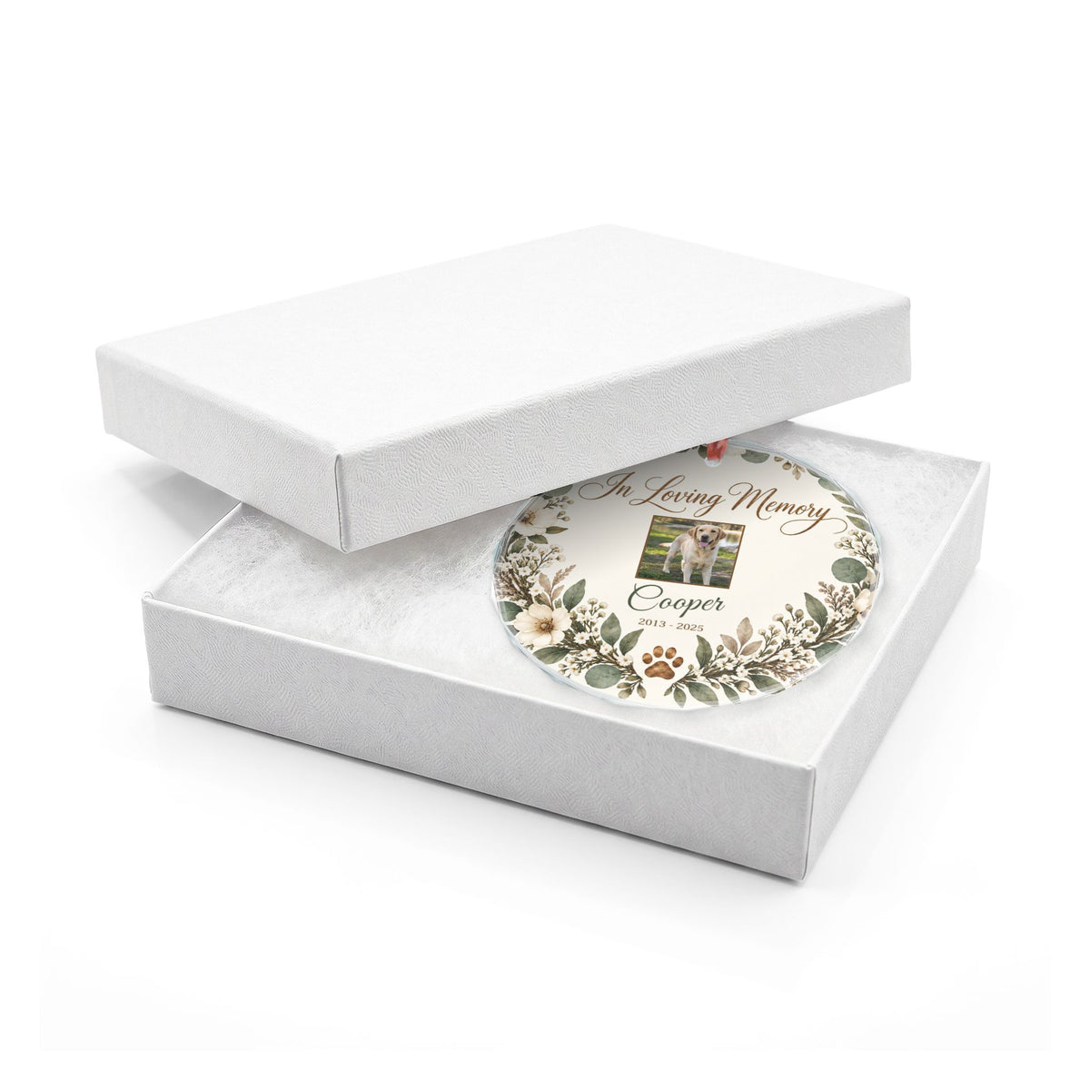 Round pet memorial glass ornament in an open white gift box