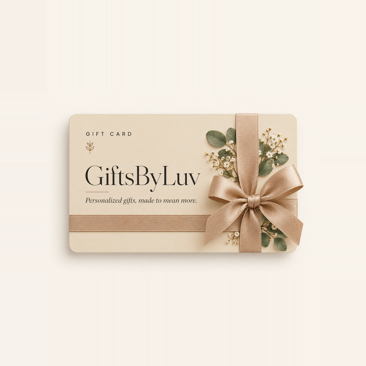 GiftsByLuv gift card in champagne with a satin ribbon and eucalyptus